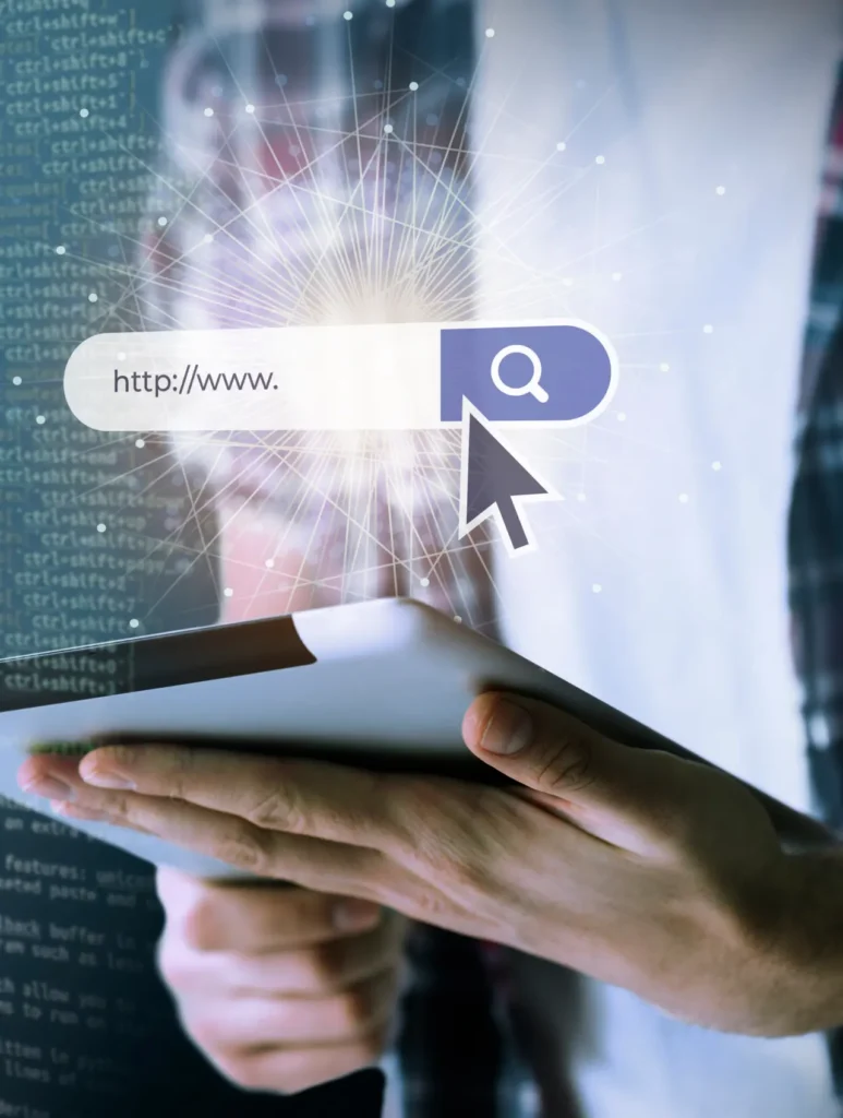 A person holding a tablet with a magnified web search bar superimposed on the image. The search bar features a cursor clicking on a search icon. In the background, there is a code-like pattern suggesting digital technology or internet browsing.
